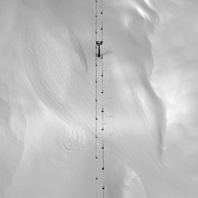 Rain-Drop — a two-seater chairlift transformed into an architectural facade piece, anchored beneath a mountain roof